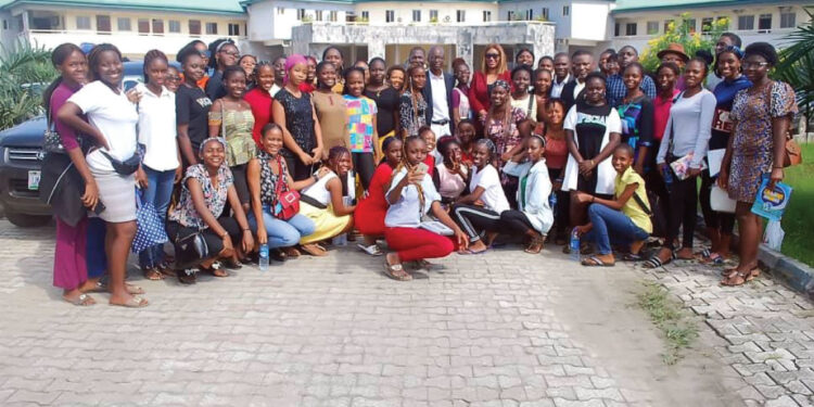 Photo News| Chief Sunny Ikeokwu and Mrs. Nwamaka Onyemelukwe in a group photograph with students