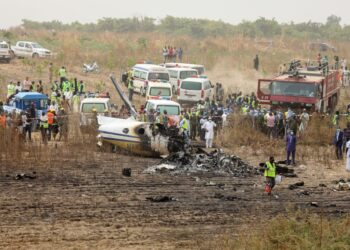 Helicopter crashes in swampy area inside creek